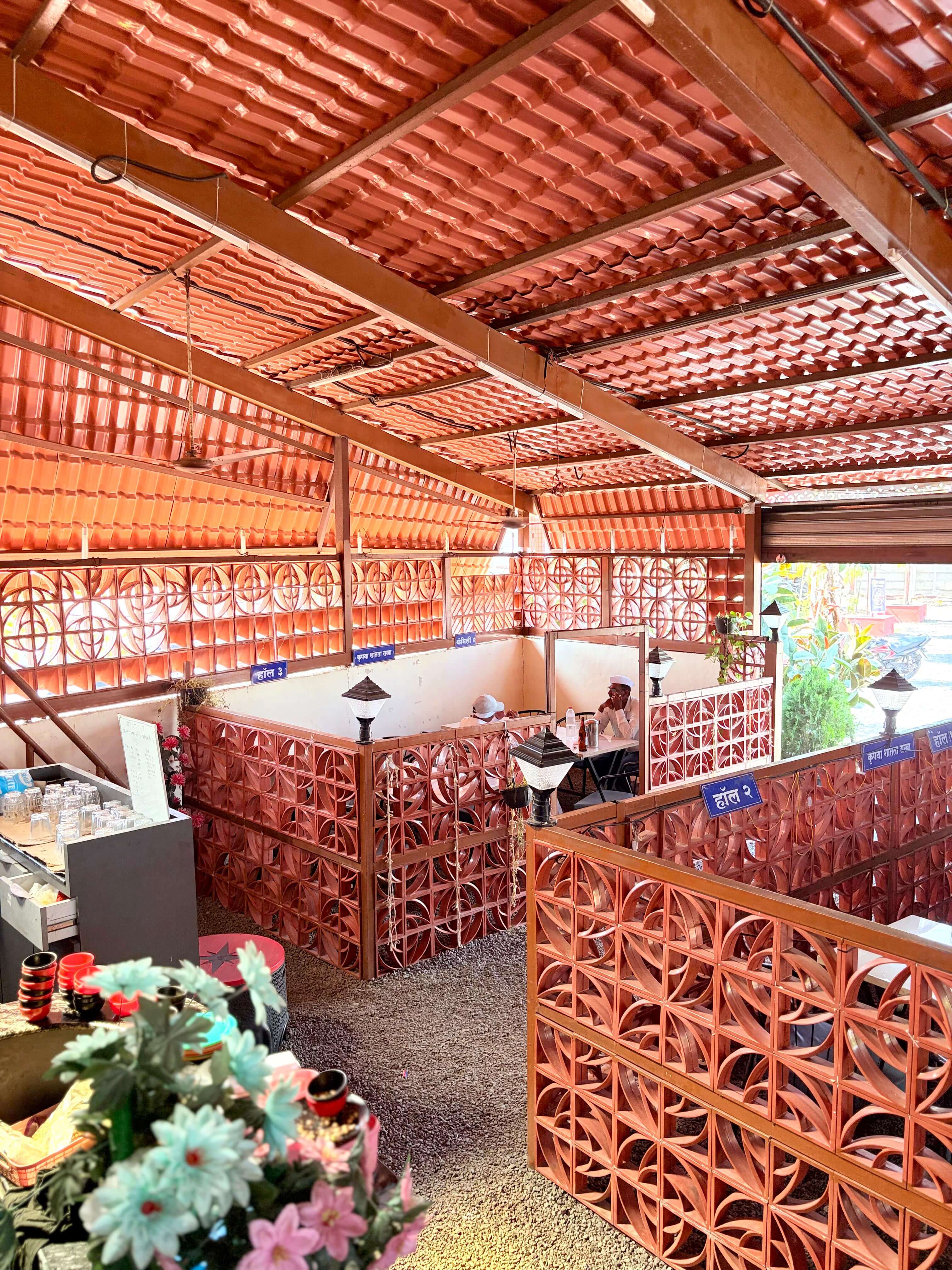 Daytime indoor dining seating area with TV